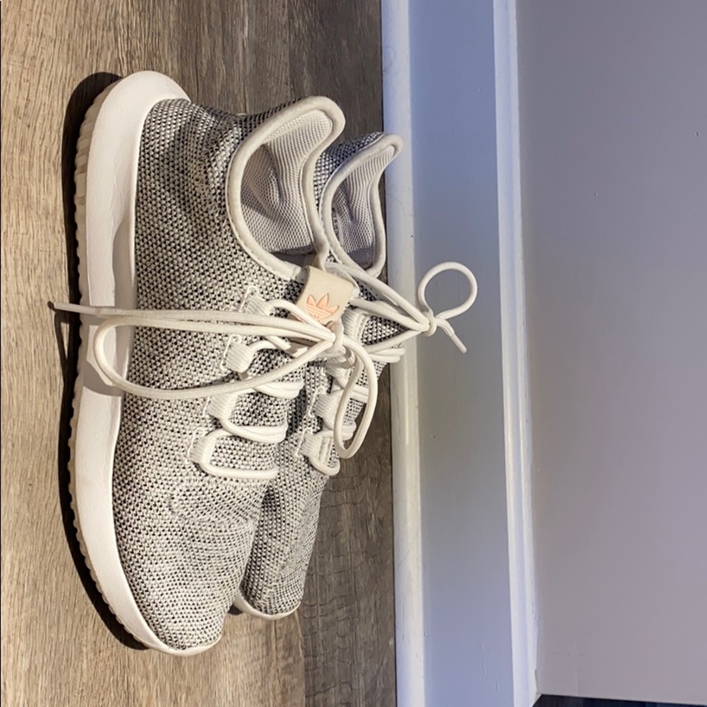 Adidas white tennis shoe.